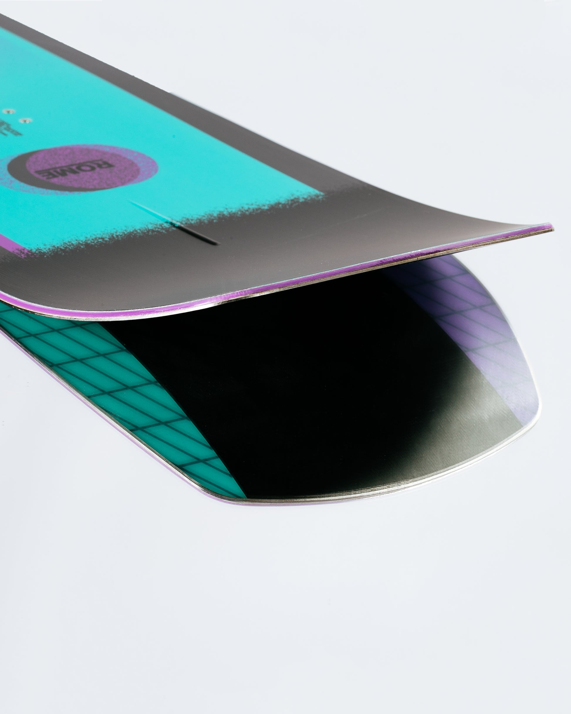 The tail and base of the freestyle snowboard with HotRods and PowerSlide base. Gang Plank 2025 | Rome Snowboards™ 2025.