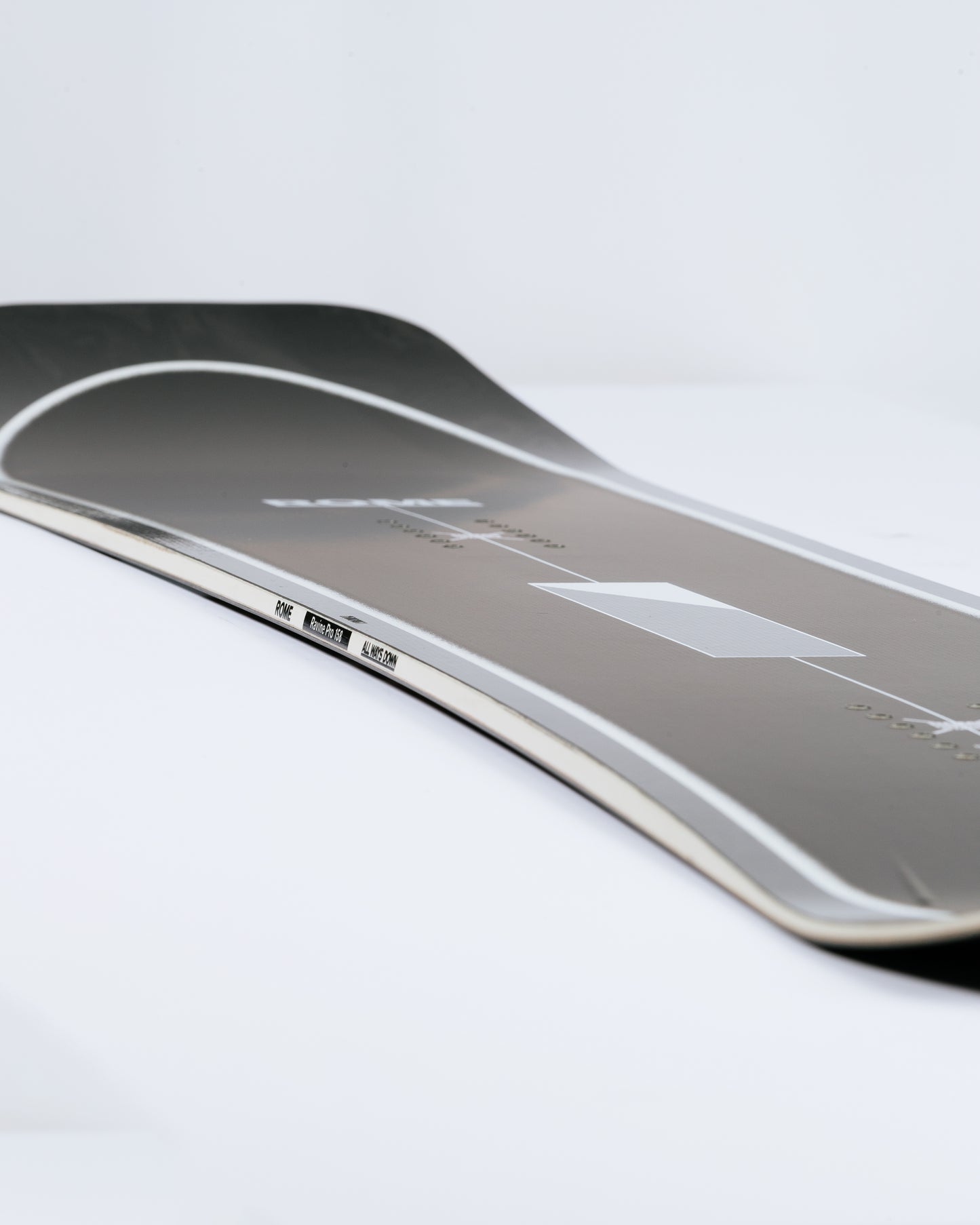 Photograph showing powder snowboard with free-the-ride camber. Ravine Pro 2025 | Rome Snowboards™